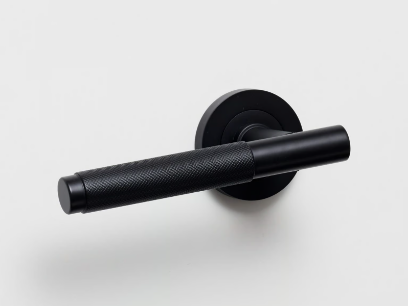 KINTORE - Brass door handle on rose by Lo & Co Interiors
