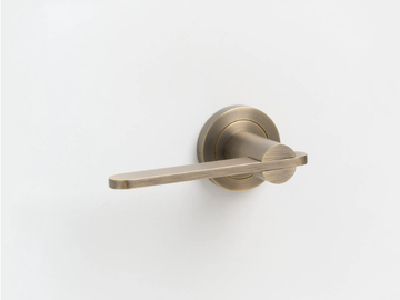 INTERSECT - Brass door handle on rose by Lo & Co Interiors