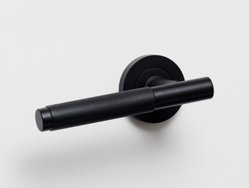 KINTORE - Brass door handle on rose by Lo & Co Interiors